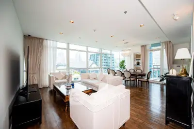 Spacious modern living room with elegant decor and city view, perfect for entertaining.