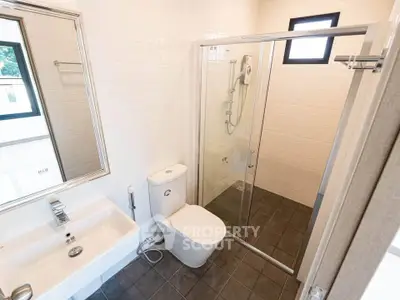 Modern bathroom with sleek fixtures and glass shower enclosure