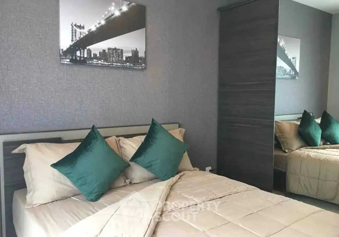 Modern bedroom with stylish decor and comfortable bedding in a contemporary apartment.