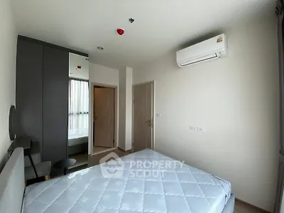 Modern bedroom with air conditioning and mirrored wardrobe in a stylish apartment.