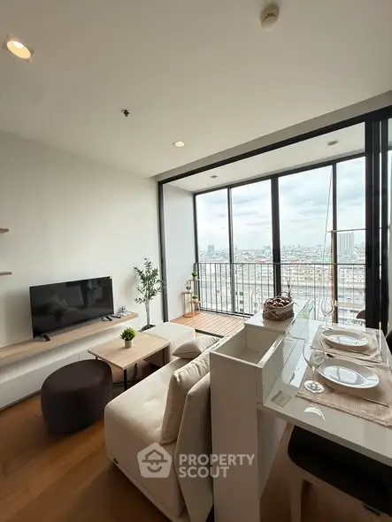 Modern living room with city view and balcony in high-rise apartment