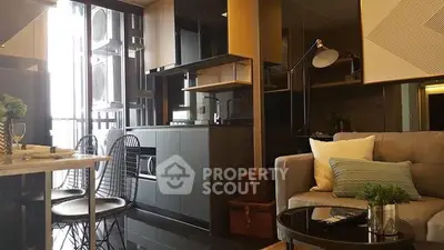Modern living room with sleek kitchen and stylish decor in a contemporary apartment.