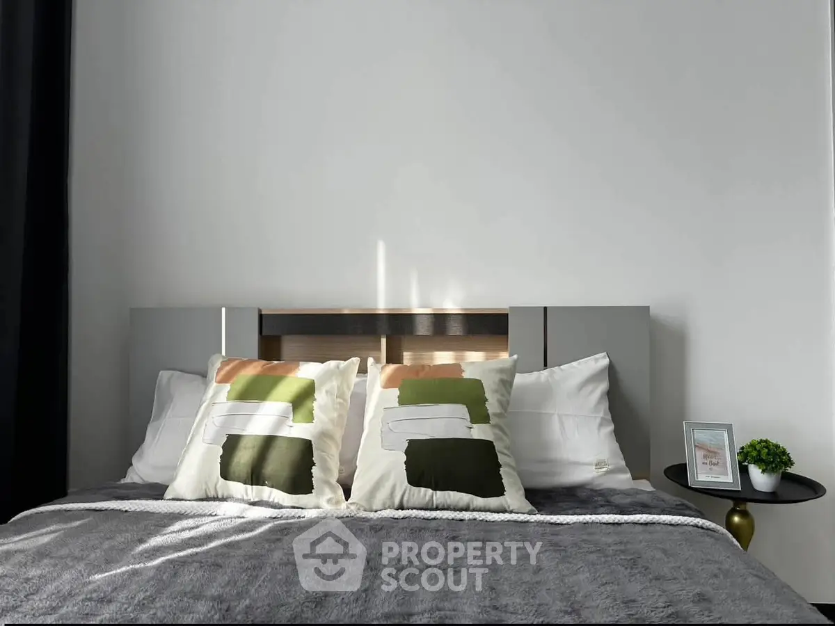 Modern bedroom with stylish pillows and cozy bedding