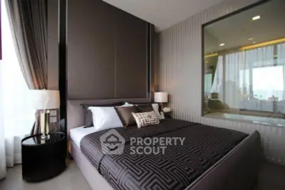 Luxurious modern bedroom with elegant decor and large window view.