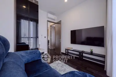 Modern living room with dark wood flooring and sleek furniture