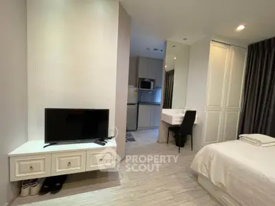 Modern studio apartment with sleek design, featuring a cozy bedroom, compact kitchen, and stylish living area.