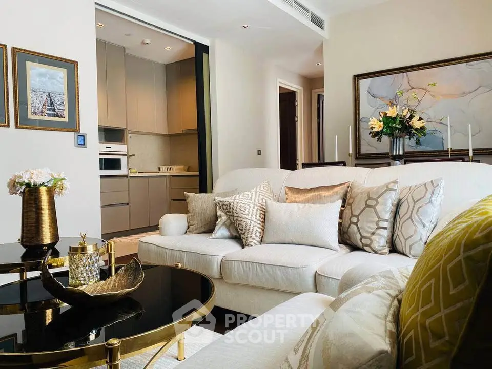 Luxurious living room with elegant decor and modern kitchen in open layout apartment.