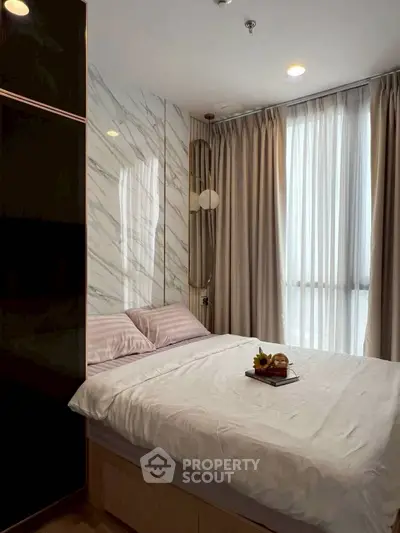 Luxurious bedroom with elegant decor and natural light, featuring a cozy bed and stylish curtains.