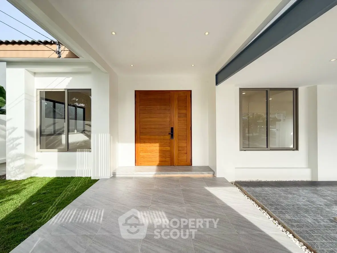 Modern house entrance with wooden door and sleek design