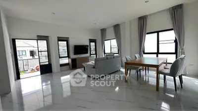 Spacious modern living room with elegant dining area and large windows