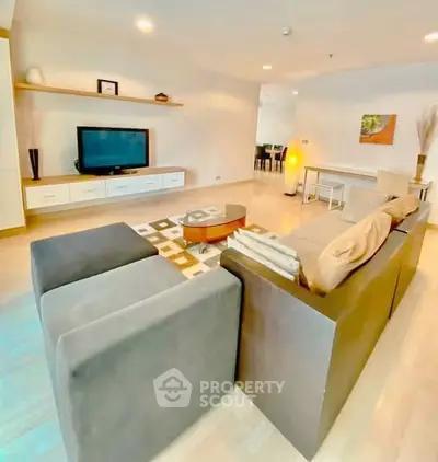 Spacious modern living room with stylish furniture and entertainment center