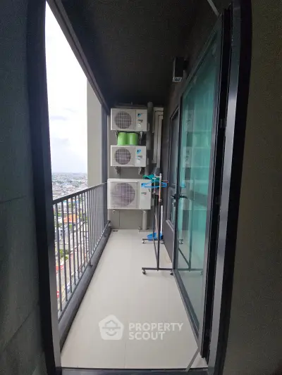 Spacious balcony with city view and air conditioning units, perfect for relaxation and enjoying the skyline.