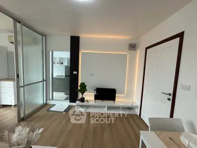 Modern living room with sleek design and ambient lighting, featuring a TV stand and sliding glass doors.
