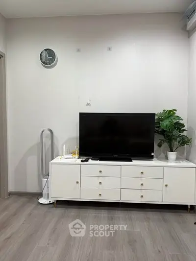 Modern living room with sleek TV stand, stylish decor, and elegant flooring.