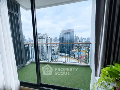 Stunning city view from a modern high-rise balcony with artificial grass flooring.