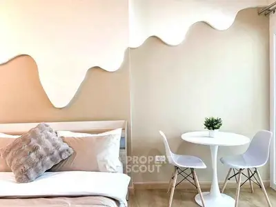 Stylish bedroom with modern decor and cozy seating area
