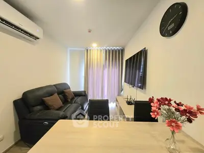 Modern living room with sleek furniture and large TV, perfect for relaxation and entertainment.
