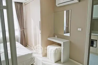 Modern bedroom with sleek design, featuring a built-in wardrobe and a cozy vanity area.