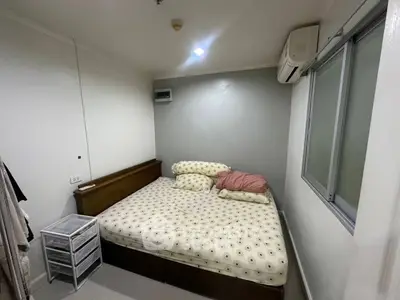 Cozy bedroom with modern air conditioning and ample natural light.