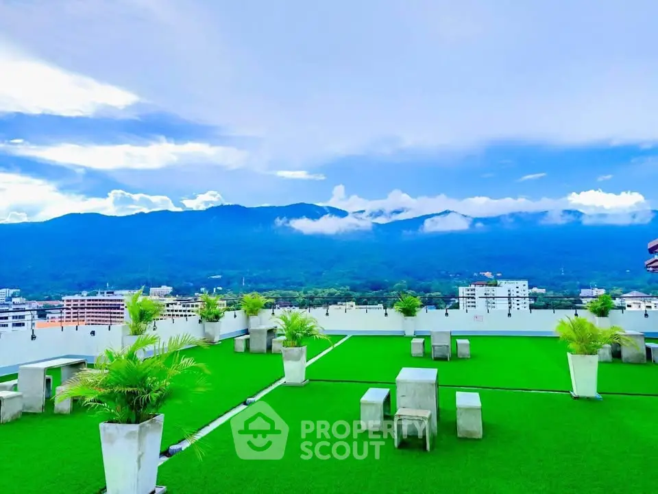 Stunning rooftop garden with panoramic mountain views and modern seating area.
