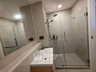 Modern bathroom with glass shower and sleek sink design