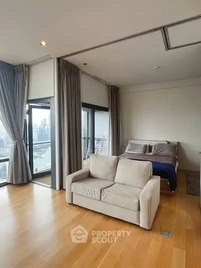 Spacious modern bedroom with city view and cozy seating area