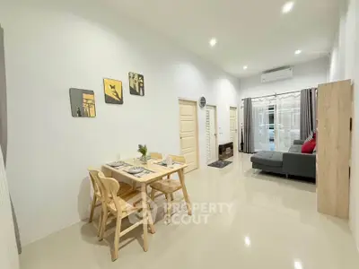 Modern living room with dining area, sleek furniture, and bright lighting.