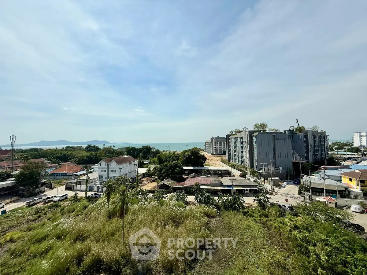 Stunning coastal view from high-rise building showcasing serene landscape and modern architecture.