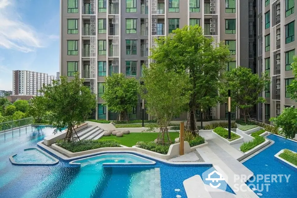 Modern condominium with luxurious pool and lush greenery