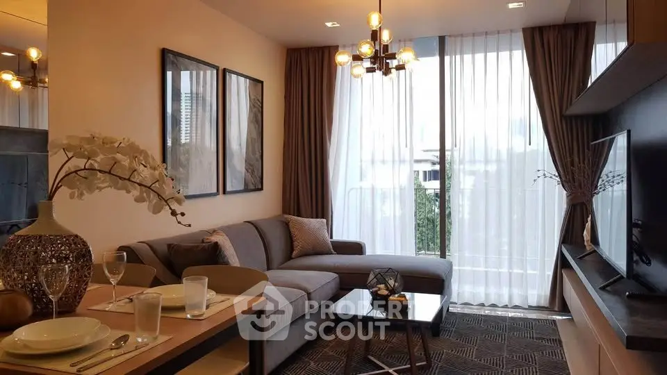Modern living room with stylish decor, large windows, and cozy seating area in a contemporary apartment.