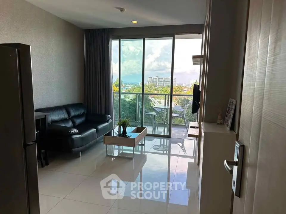 Modern living room with balcony and scenic view, perfect for relaxation.