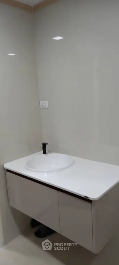Modern bathroom with sleek white vanity and minimalist design