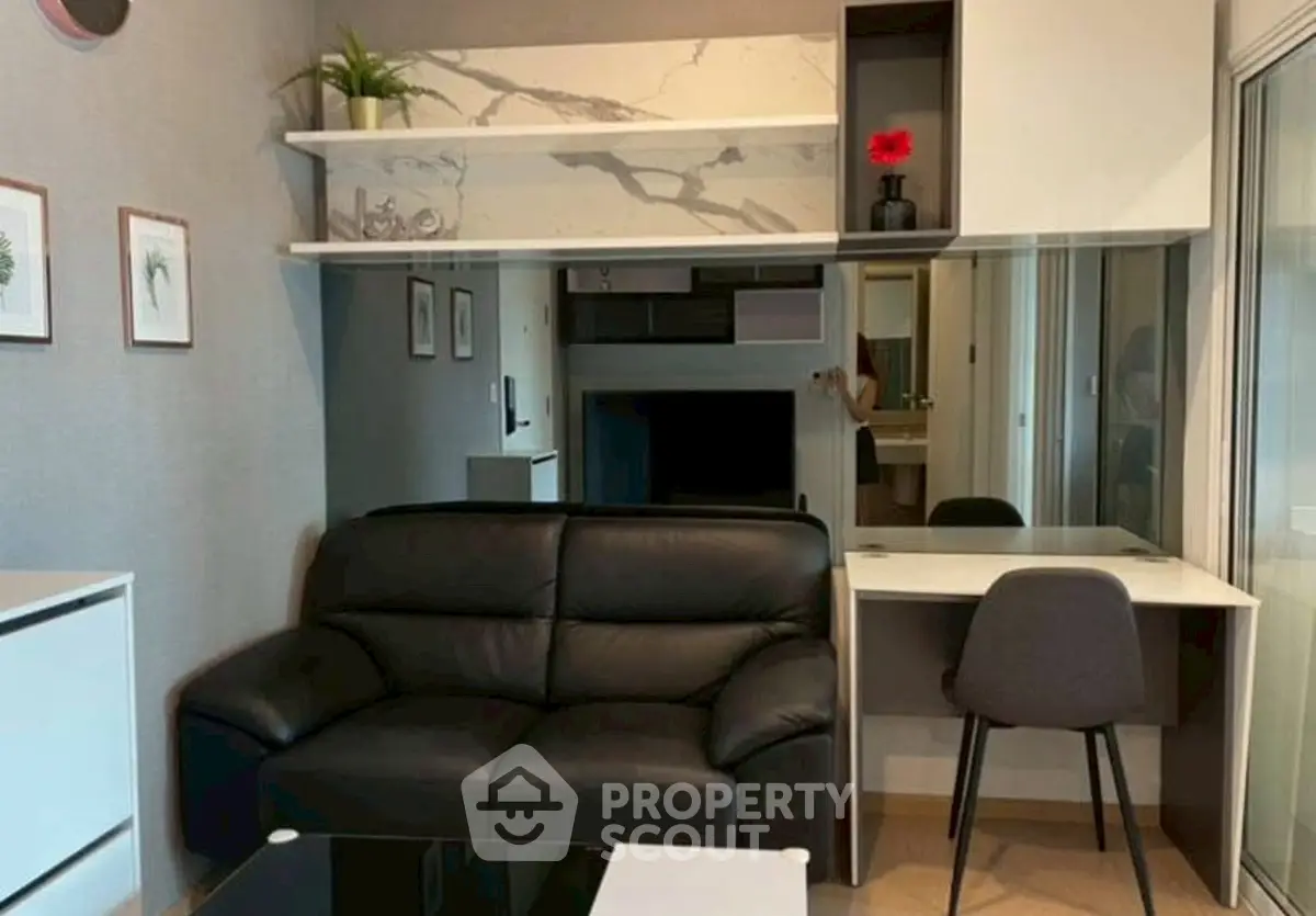 Modern living room with black leather sofa and stylish decor