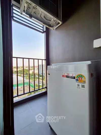 Modern balcony with washing machine and scenic city view, perfect for urban living convenience.
