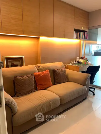Cozy living room with plush sofa and modern lighting, perfect for relaxation.