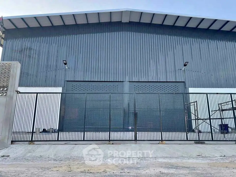 Spacious industrial warehouse with secure gated entrance and modern design.