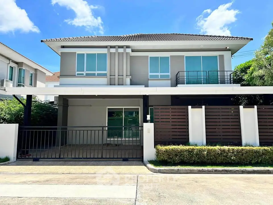 Modern two-story house with sleek design and spacious driveway in a serene neighborhood.