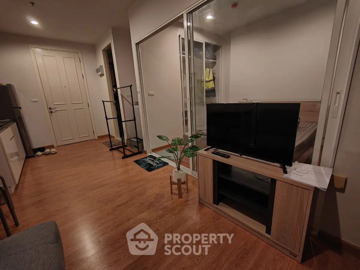 Modern living room with wooden flooring and sleek TV stand