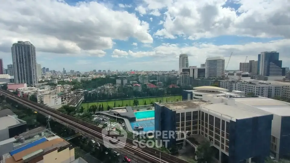 Stunning cityscape view with lush greenery and modern buildings under a vibrant sky.