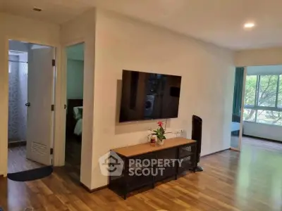 Spacious living room with wall-mounted TV and large window view