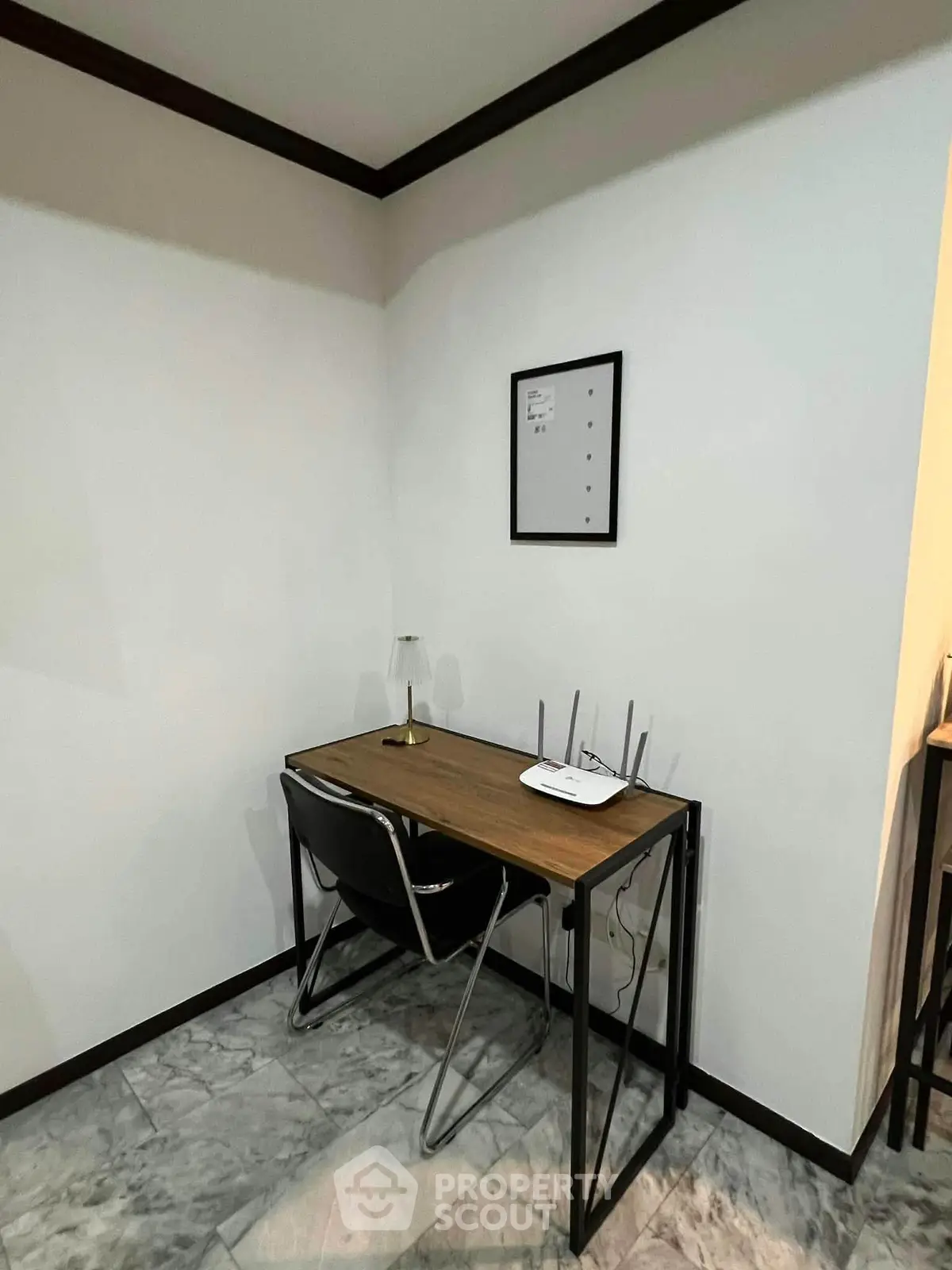 Cozy study nook with modern desk and chair in a minimalist interior setting.