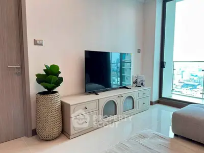 Modern living room with sleek TV stand and large window offering city view