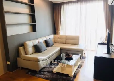 Modern living room with stylish sectional sofa and large window for natural light.