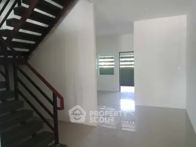 Spacious interior with modern staircase and glossy flooring, ideal for customization.
