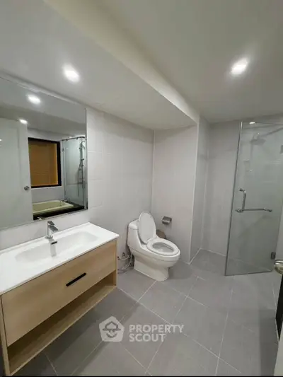 Modern bathroom with sleek fixtures and glass shower enclosure