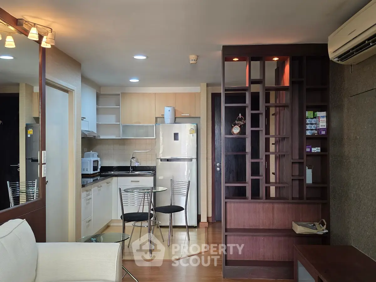 Modern open-layout kitchen with dining area and stylish partition in cozy apartment.