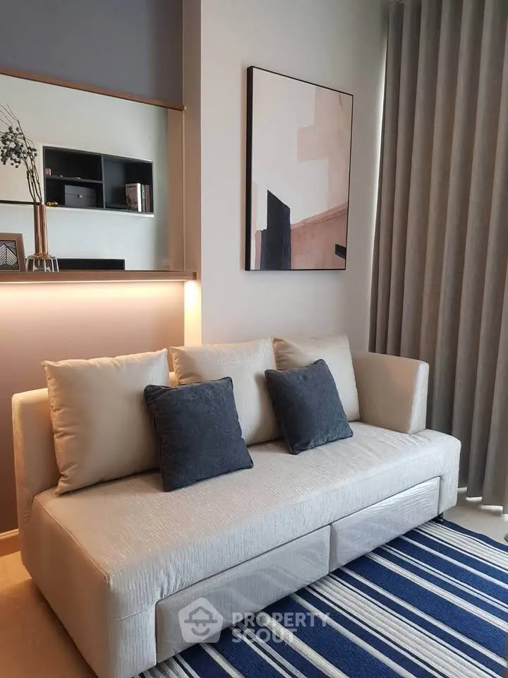Modern living room with stylish sofa and abstract art, featuring elegant decor and cozy ambiance.