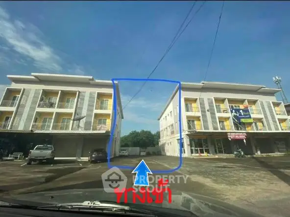 Modern apartment building with spacious balconies and ample parking space