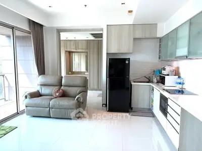 Modern open-layout living room with sleek kitchen and balcony view