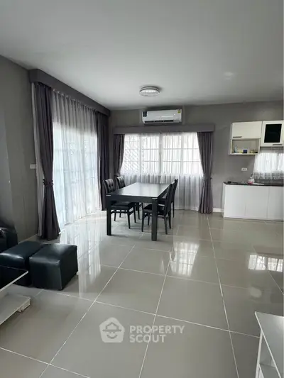 Spacious modern living room with dining area and large windows